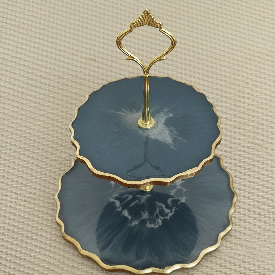Two-tiered blue agate dish with gold trim on a beige background