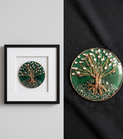 Decorative circular piece with tree design on a green background, framed on a gray wall.